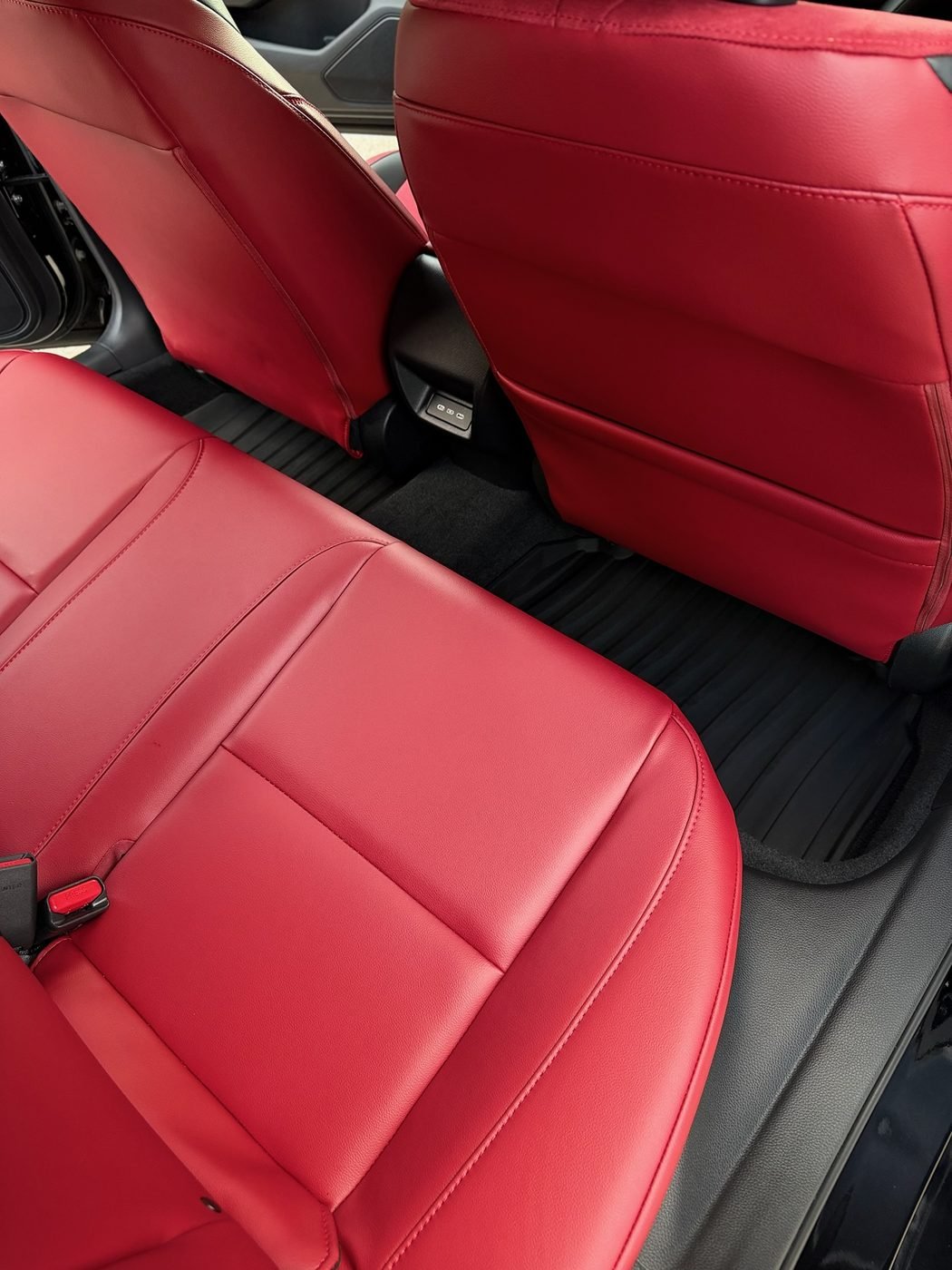 Acura Integra red leather rear seats cleaned and conditioned during an interior detail